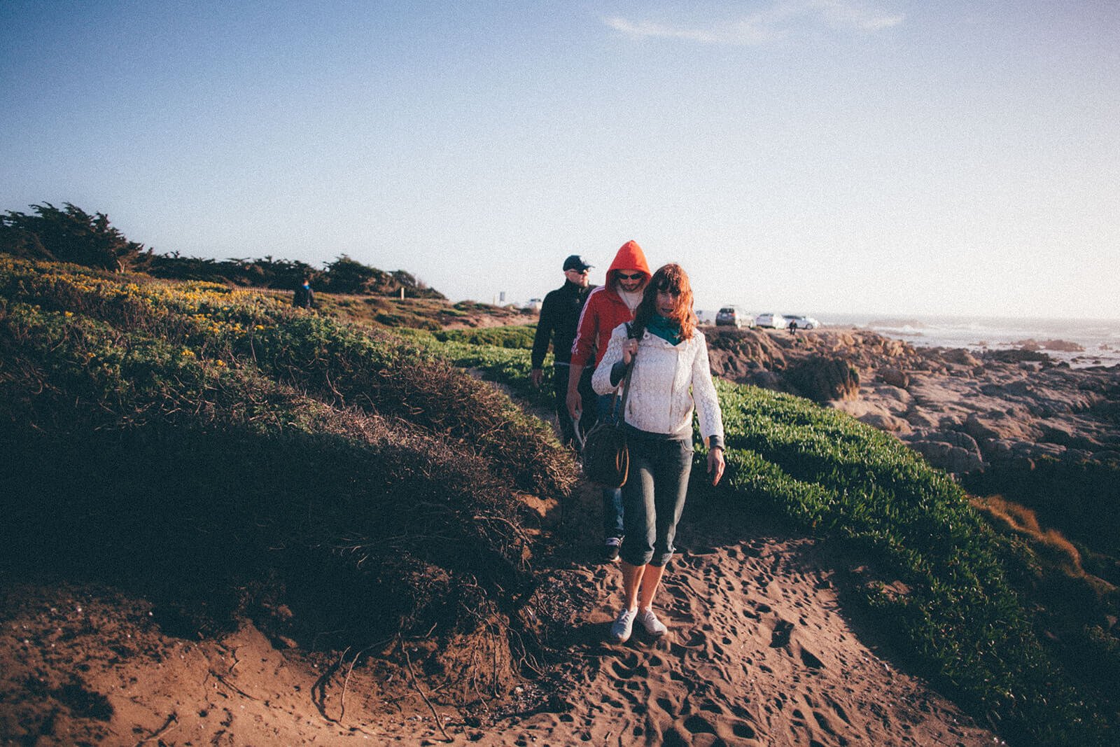 Family walking along a beach path in New England